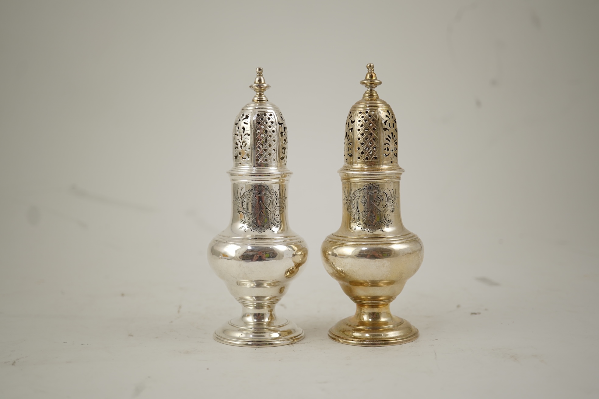 A pair of George II silver baluster sugar casters, by Samuel Wood